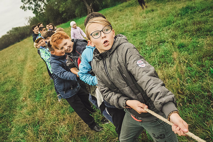 children playing tug of war rope game